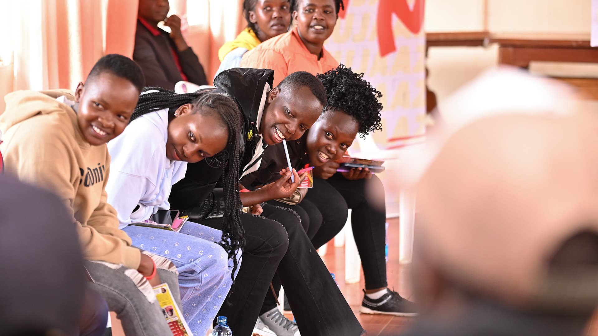 Young Kenyans laughing together at a Surround Sound Kenya session