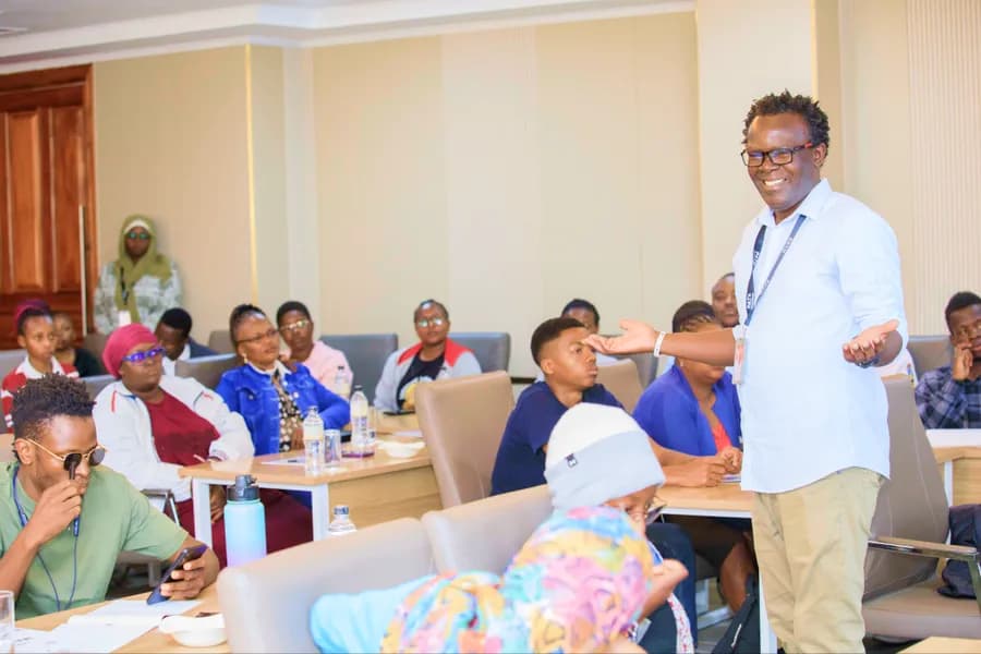 A facilitator standing in a classroom session